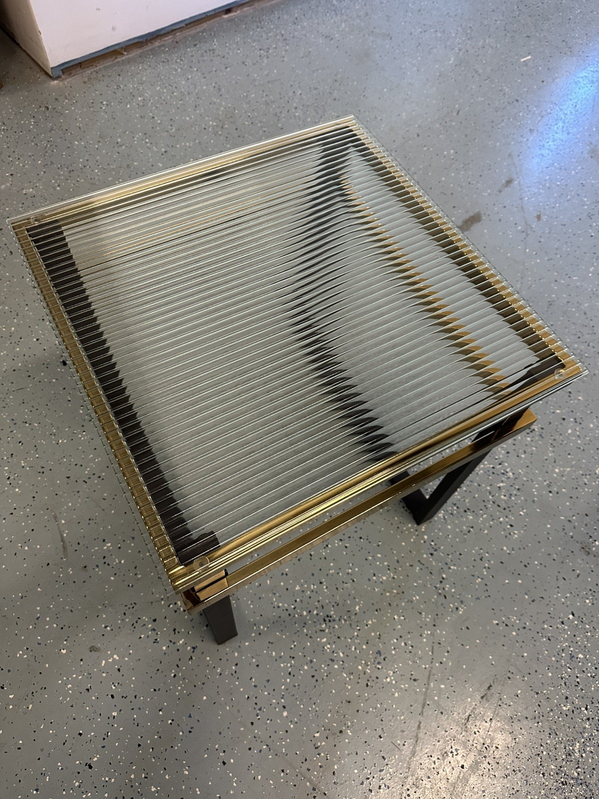 End/side table, square ribbed/fluted glass top and a black and gold metal frame