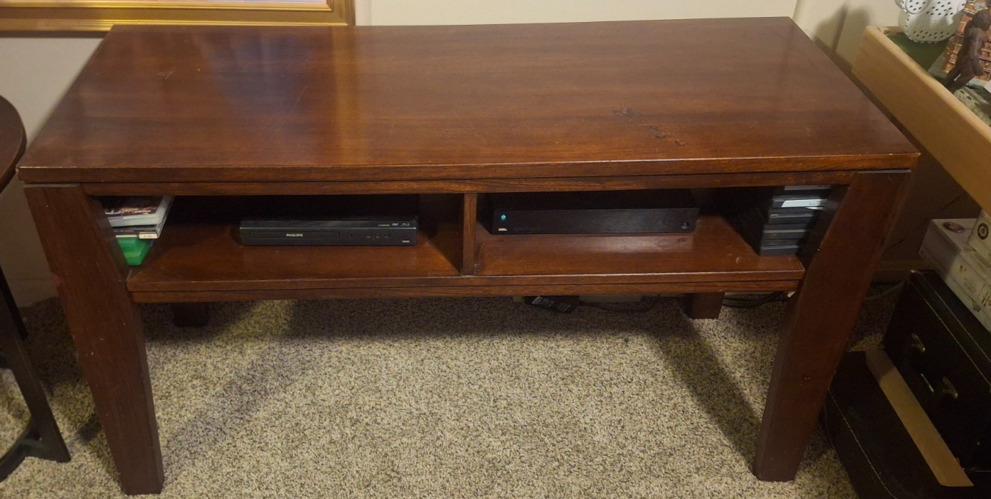 brown tv stand wood open face. you could put a big tv on it .its strong used