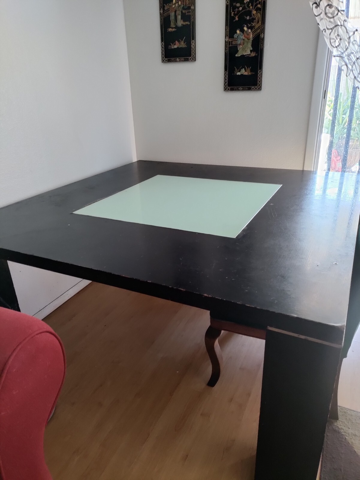 Kitchen table  62″x62″ square Black with a glass square in the middle.